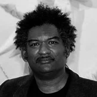 Black and white portrait photograph of artist Elio Rodrigeuz.