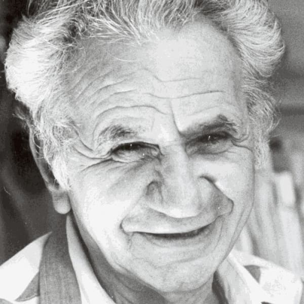 Photograph os a smiling man with white hair and cleanly shaven.